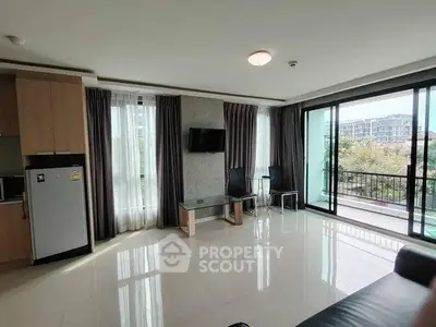 Spacious modern living room with large windows and balcony view