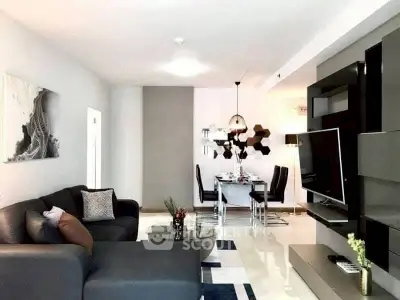 Modern living room with sleek furniture and stylish dining area, perfect for contemporary living.