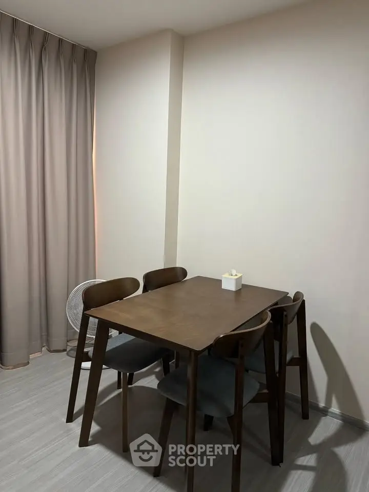 Cozy dining area with wooden table and chairs, perfect for intimate gatherings.