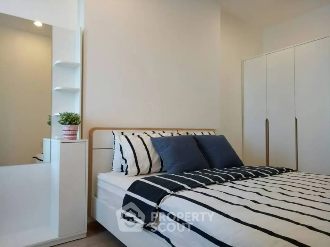 Modern bedroom with stylish decor and ample storage space