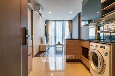 Modern apartment interior with open layout, featuring a sleek kitchen and cozy living area.