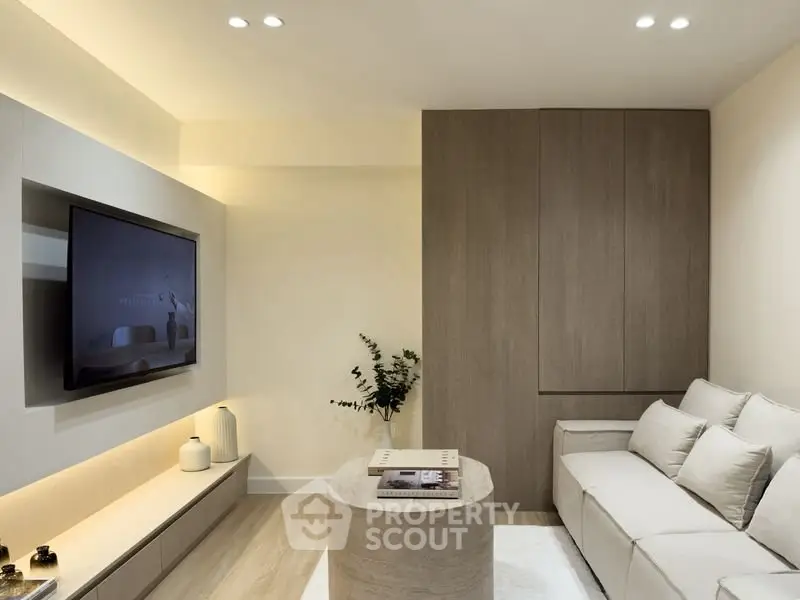 Modern living room with sleek design, neutral tones, and built-in storage.