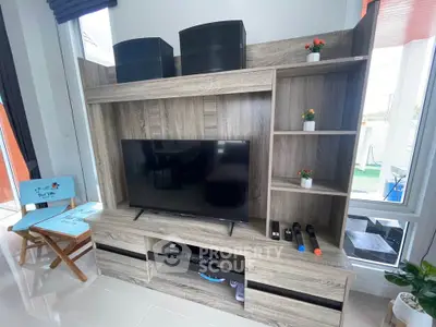 Modern living room with stylish wooden entertainment center and large TV