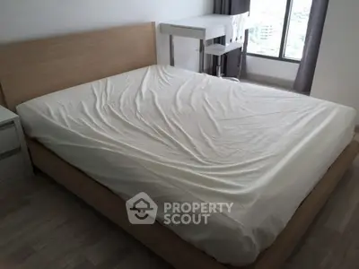 Spacious bedroom with modern furniture and large window view