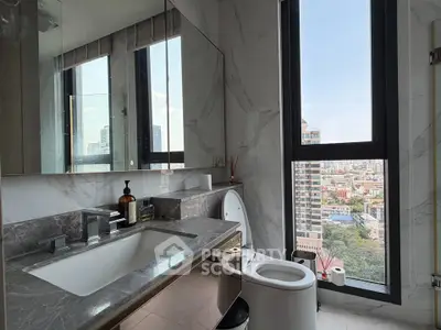 Luxurious bathroom with city view, featuring marble countertops and modern fixtures.