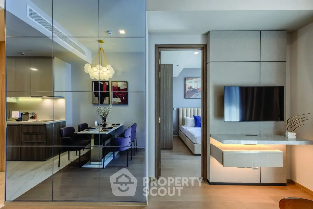 Modern open-plan living and dining area with sleek decor and stylish furnishings.
