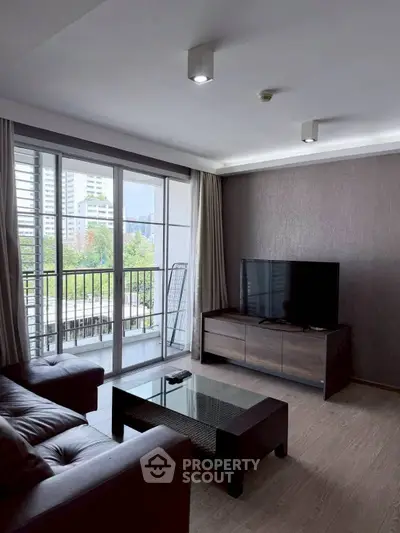 Modern living room with sleek furniture and balcony view in urban apartment