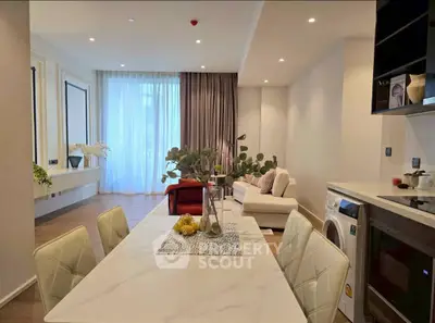 Modern open-plan living and dining area with elegant decor and natural light.