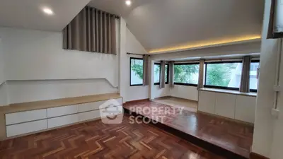 Spacious modern living room with hardwood floors and large windows