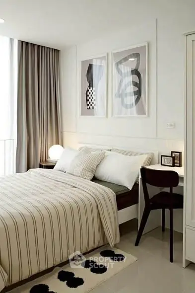 Modern bedroom with stylish decor and natural light, featuring a cozy bed and elegant furnishings.