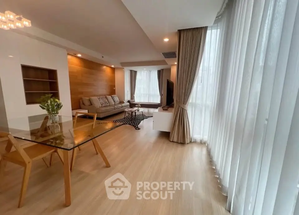 Spacious modern living room with large windows and elegant decor