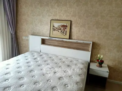 Cozy bedroom with elegant decor and natural light, featuring a stylish bed and nightstand.