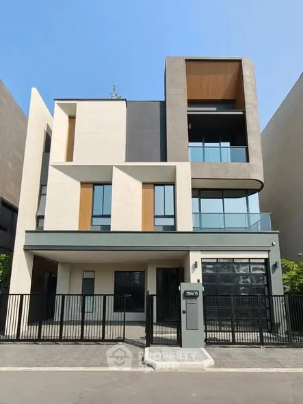 Modern three-story building with sleek design and large windows in urban setting.