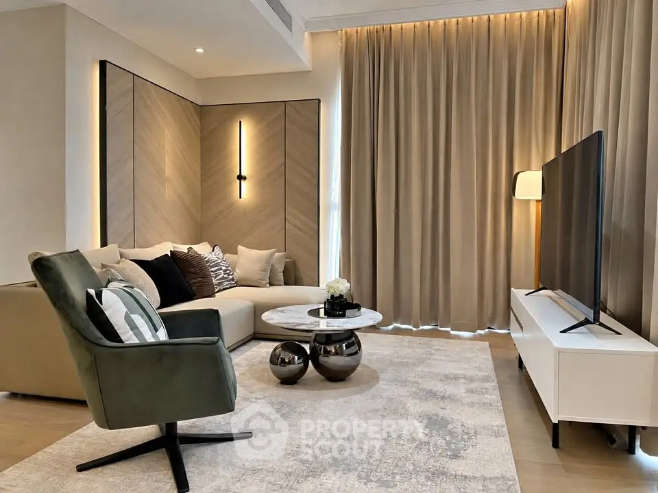Modern living room with stylish furniture and large TV, featuring elegant lighting and cozy ambiance.