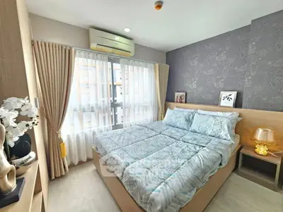 Cozy bedroom with modern decor, large window, and stylish furnishings in a contemporary apartment.
