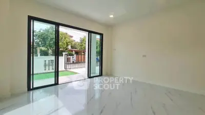 Spacious room with sliding glass doors opening to a private garden view.