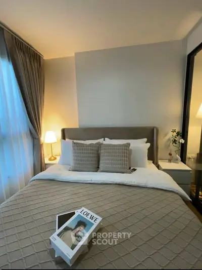 Cozy bedroom with elegant decor and soft lighting, featuring a comfortable bed and stylish accents.