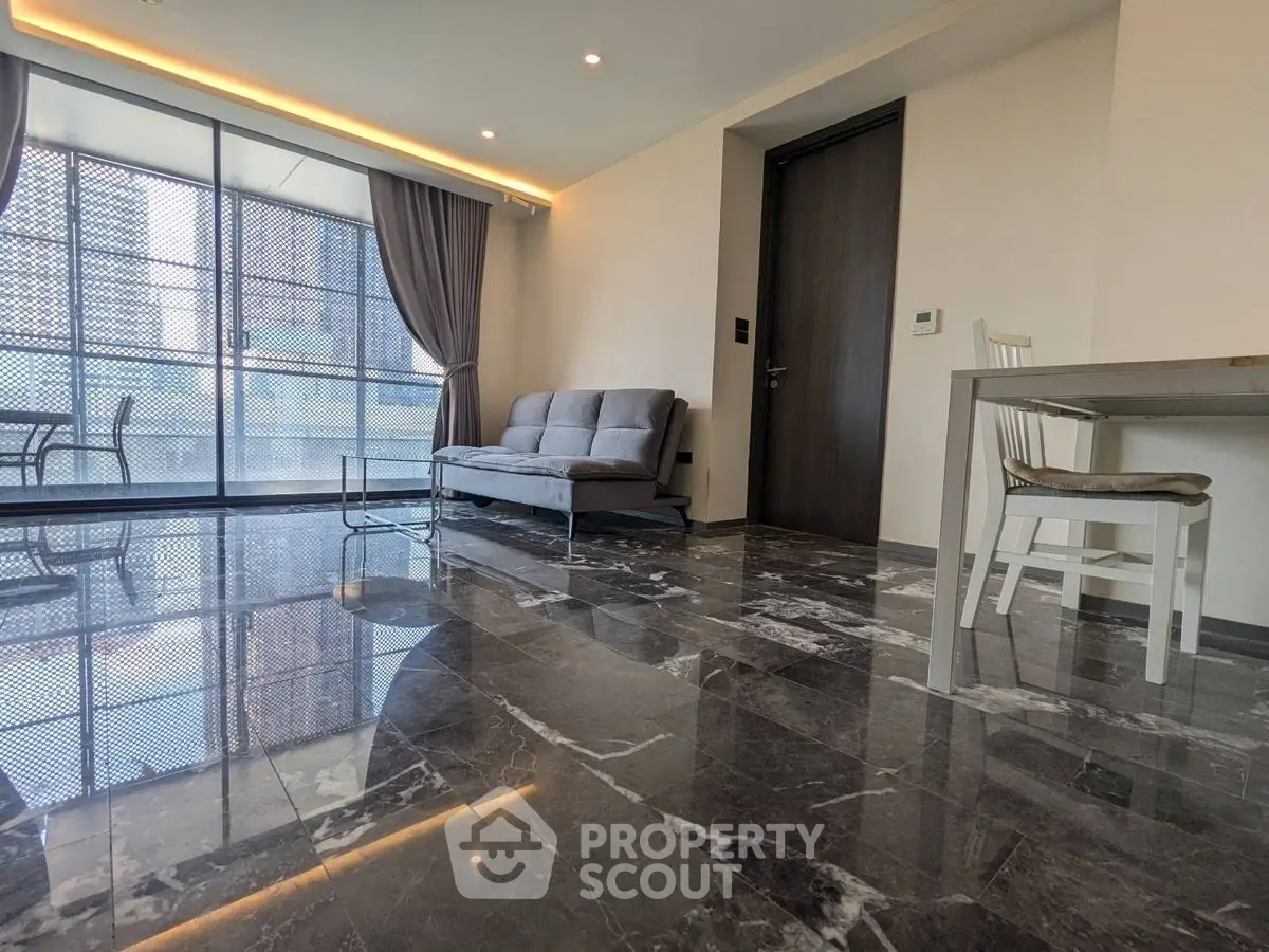 Modern living room with marble floors and large windows in a high-rise apartment.
