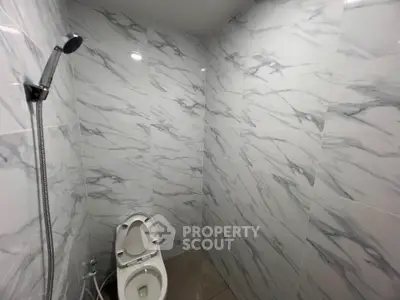 Modern bathroom with marble tiles and sleek shower design