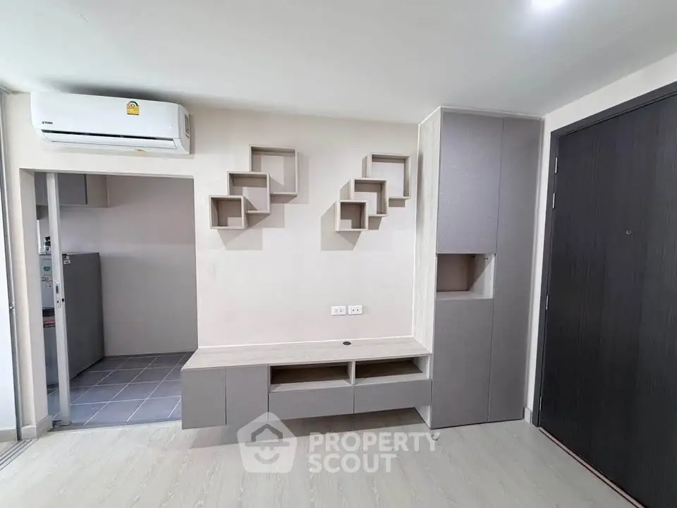 Modern minimalist living room with built-in storage and air conditioning