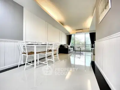 Spacious modern living room with elegant dining area and large windows for natural light.