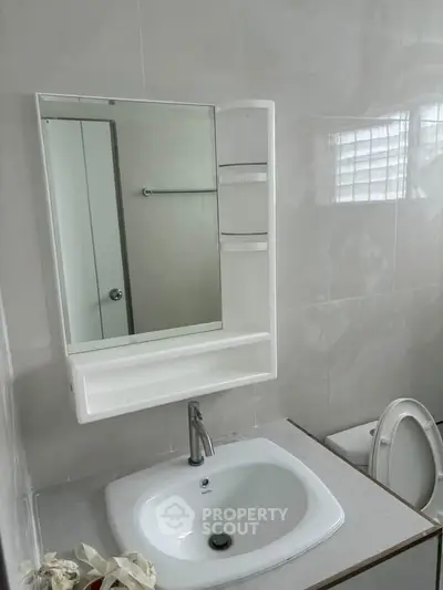 Modern bathroom with sleek sink and mirror cabinet, perfect for contemporary living.