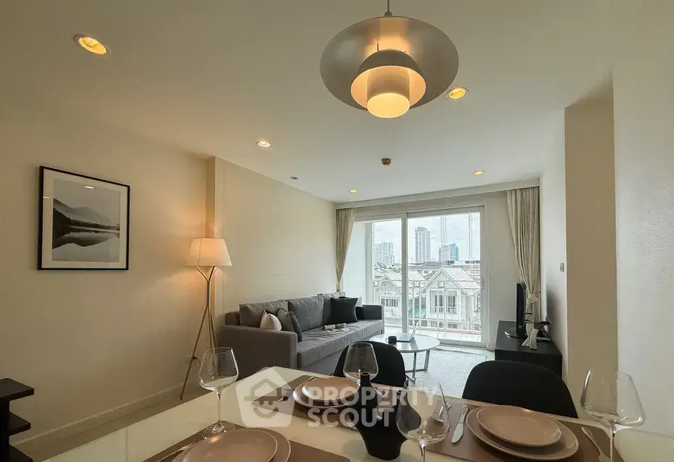 Modern living room with elegant dining area and city view from large windows.