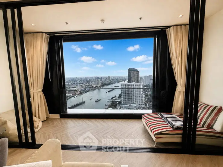 Luxurious living room with stunning city and river view from high-rise apartment.