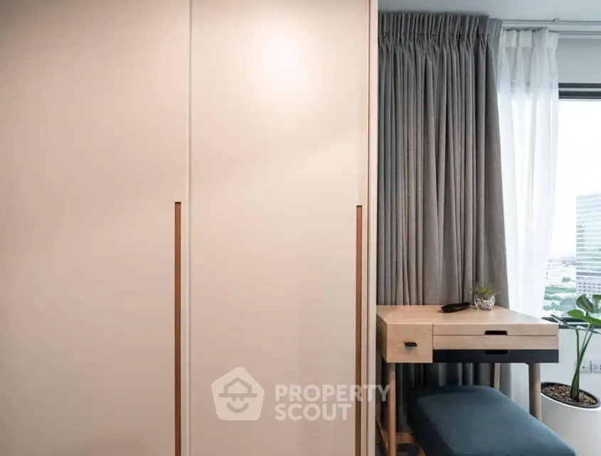 Modern study nook with desk and window view in stylish apartment.
