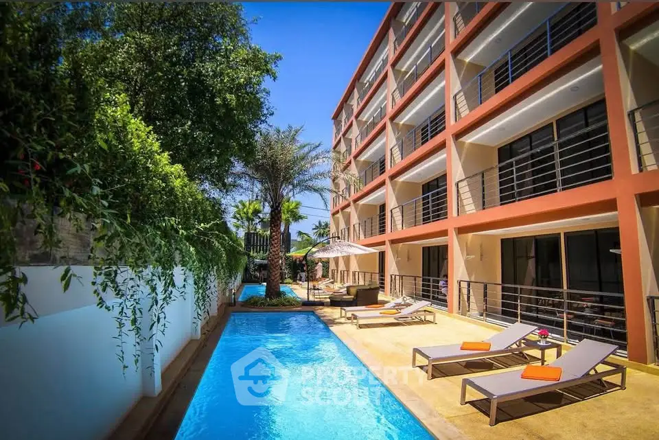 Luxurious apartment complex with a stunning outdoor pool and lush greenery, perfect for relaxation and leisure.