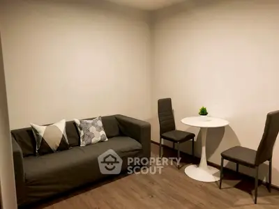 Cozy living room with modern sofa and dining set, perfect for urban living.