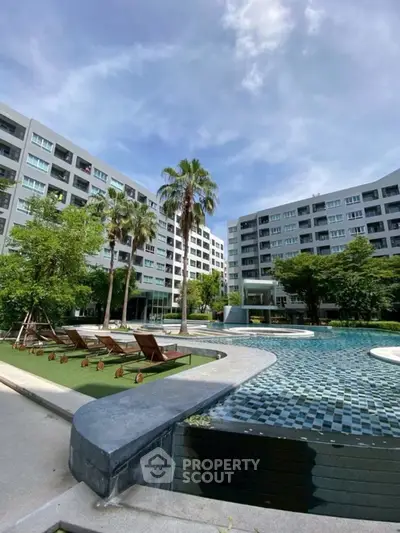 Luxurious condominium with stunning pool and lush garden view