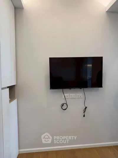 Modern living room with wall-mounted TV and sleek cabinetry, perfect for contemporary living.