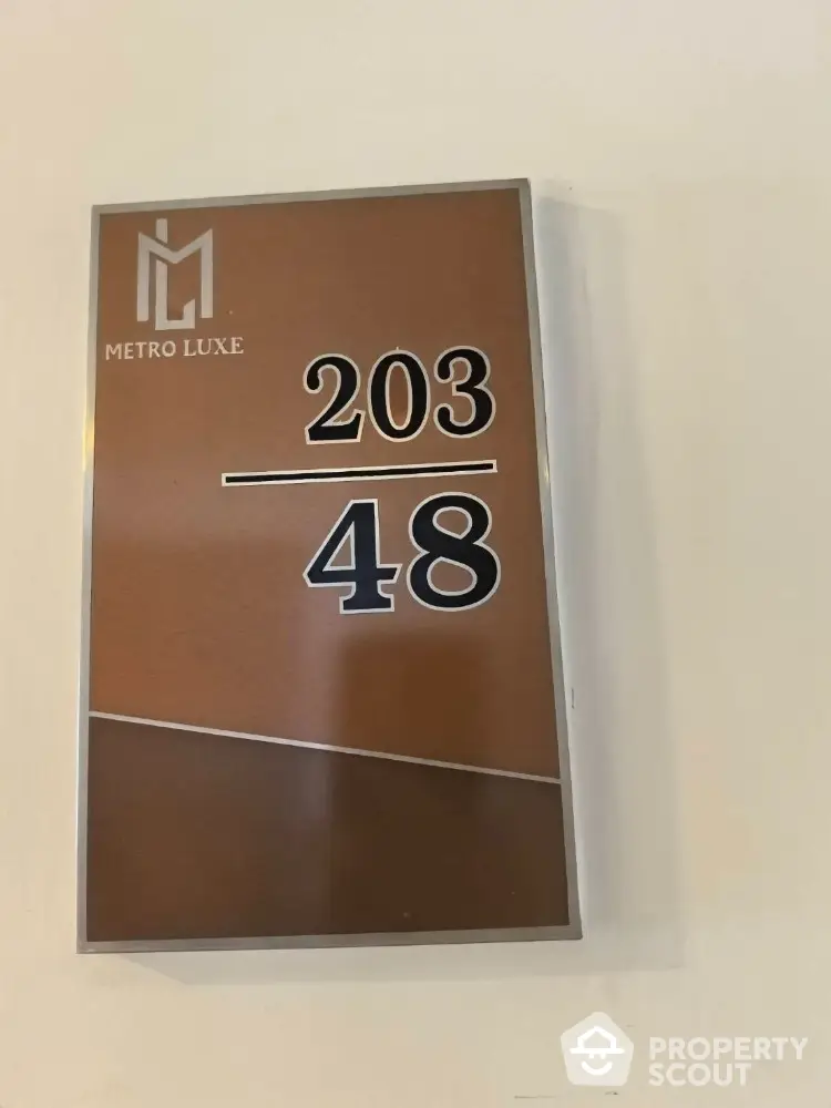 Stylish Metro Luxe apartment number sign with modern design