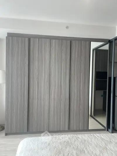 Spacious bedroom with modern sliding wardrobe and elegant decor