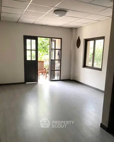 Spacious living room with open balcony and natural light