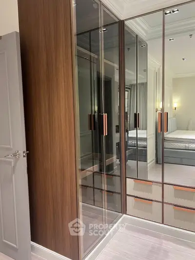 Luxurious bedroom with mirrored wardrobe and elegant lighting