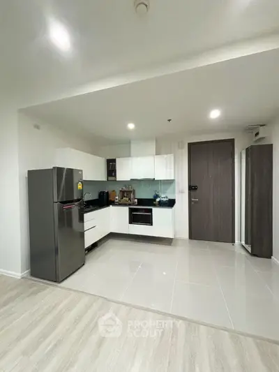 Modern kitchen with sleek appliances and minimalist design in a contemporary apartment.
