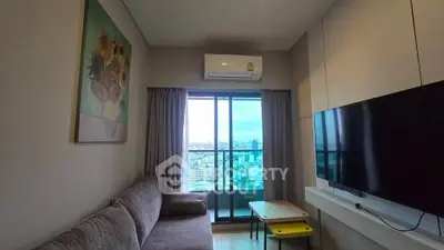 Modern living room with city view, featuring a cozy sofa, wall-mounted TV, and air conditioning.