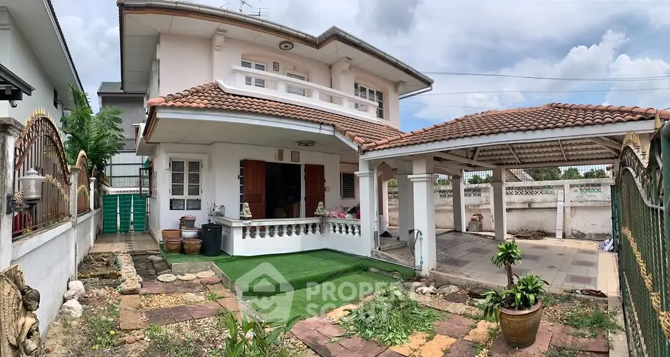 Charming two-story house with tiled roof and spacious front yard, perfect for family living.