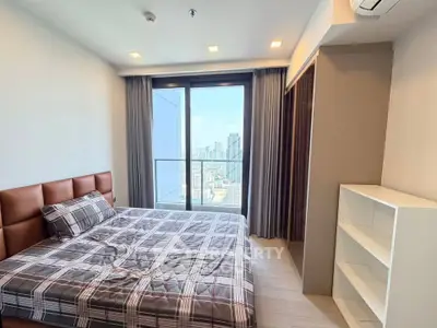 Modern bedroom with city view and stylish decor in high-rise apartment
