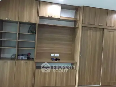 Spacious wooden built-in storage unit with ample shelving and cabinets