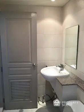 Modern bathroom with sleek sink and mirror in stylish apartment