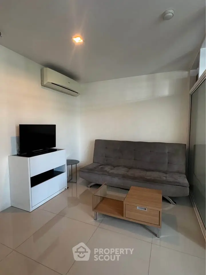 Modern living room with sleek furniture and air conditioning in a cozy apartment.