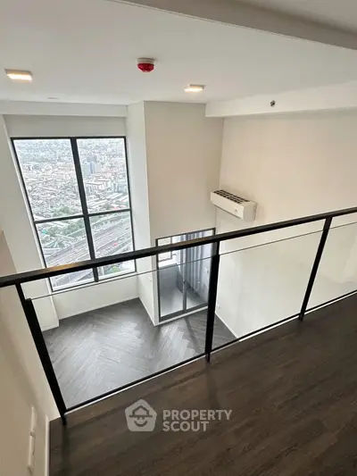 Modern loft apartment with stunning city view and sleek interior design.