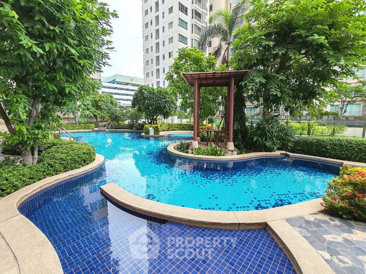 Luxurious outdoor pool area with lush greenery and modern design in urban setting.