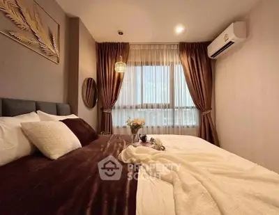 Luxurious bedroom with elegant decor and large window offering natural light.