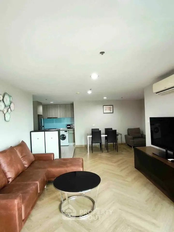 Spacious modern living room with open kitchen and stylish furniture in a contemporary apartment.