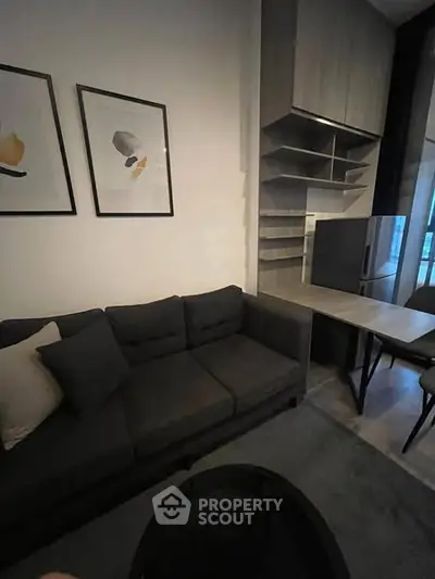 Modern living room with stylish sofa and wall art in a cozy apartment setting.
