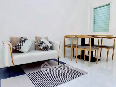 Modern minimalist living room with stylish sofa and dining set
